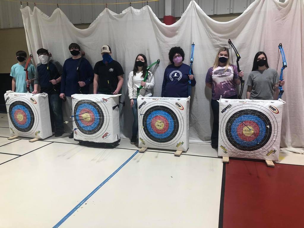 Students in PE class learning archery